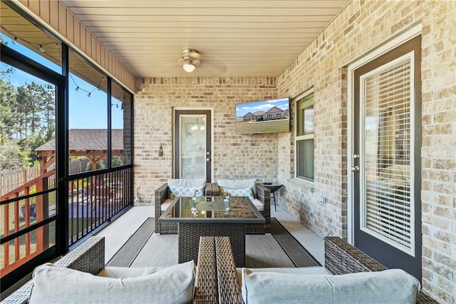 sunroom / solarium featuring ceiling fan and wooden ceiling