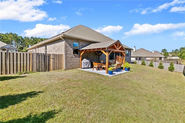 rear view of house featuring a patio and a lawn