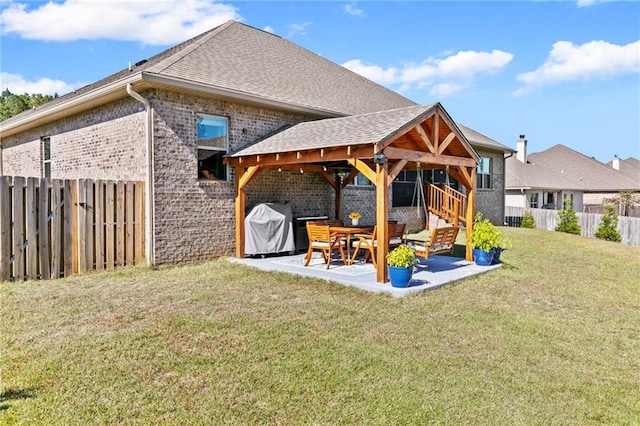 rear view of house with a lawn and a patio area