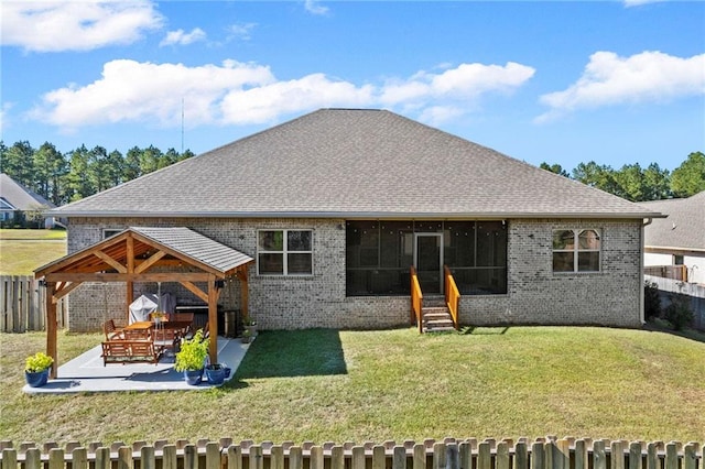 back of house featuring a patio area and a yard