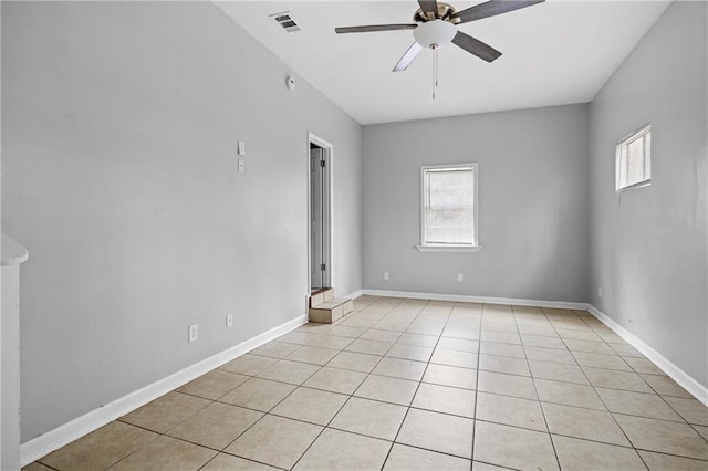 tiled empty room with ceiling fan