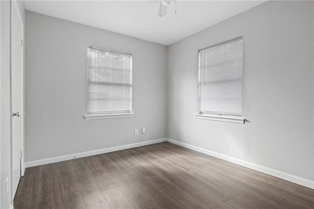 unfurnished room with dark wood-type flooring and ceiling fan