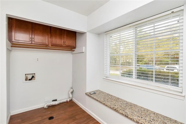 clothes washing area with hardwood / wood-style floors, cabinets, and washer hookup