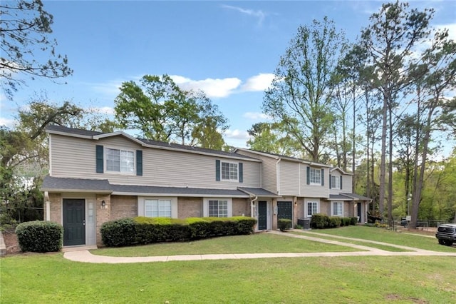 view of front facade with a front lawn and central AC