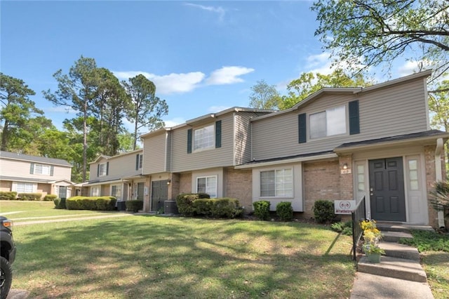 view of front facade with central AC and a front lawn