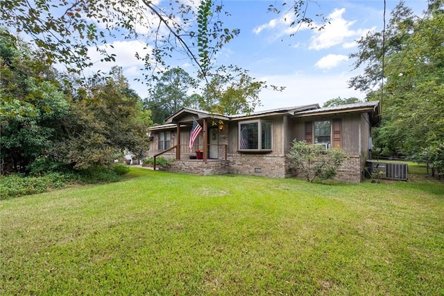 view of front of home with central AC and a front yard