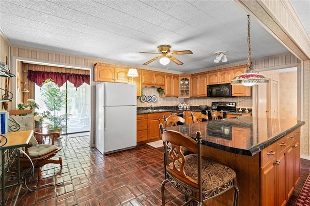 kitchen with black appliances, ceiling fan, hanging light fixtures, and tasteful backsplash