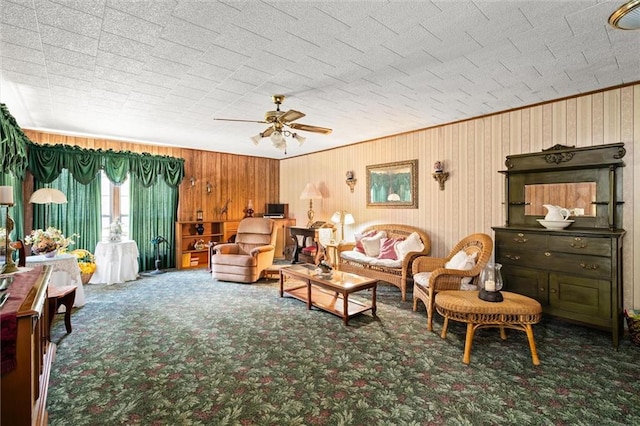 living room with carpet, wooden walls, and ceiling fan