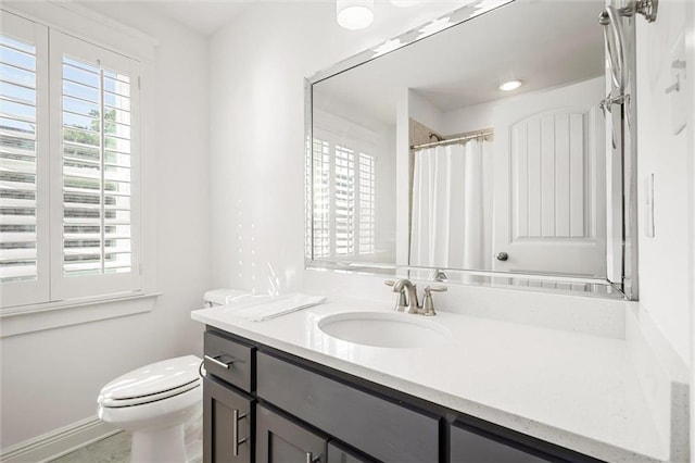 full bath with toilet, curtained shower, vanity, and a wealth of natural light