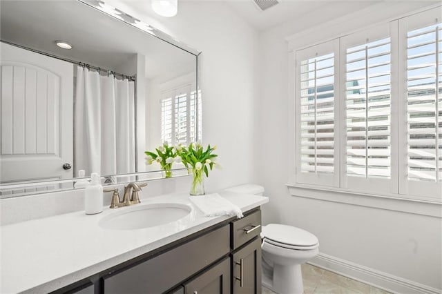 full bath with curtained shower, vanity, toilet, and baseboards