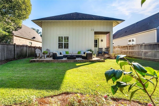 back of house with a lawn, a patio, a fenced backyard, an outdoor hangout area, and board and batten siding