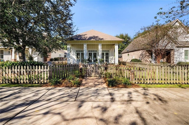 view of front of house featuring french doors, a fenced front yard, and board and batten siding