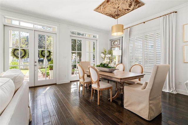 dining room featuring ornamental molding, french doors, dark wood-type flooring, and baseboards