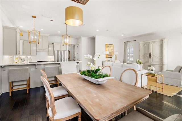 dining area with recessed lighting, dark wood-style flooring, and crown molding