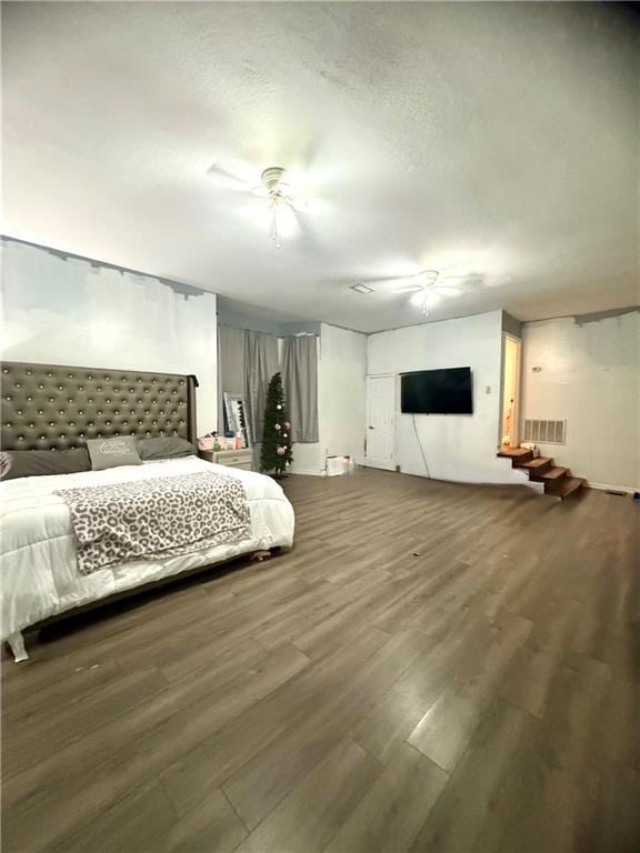 bedroom featuring hardwood / wood-style flooring and a textured ceiling