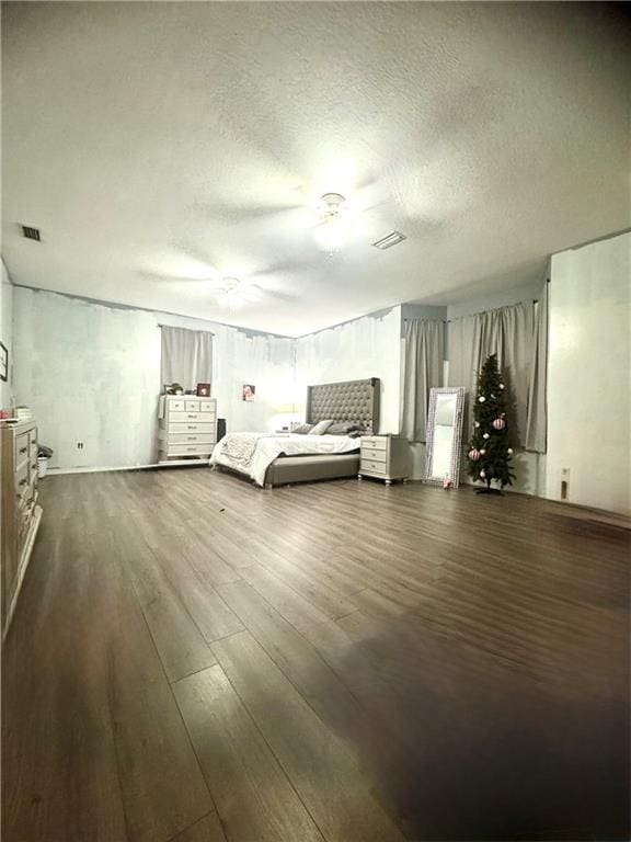 unfurnished bedroom featuring dark wood-type flooring and a textured ceiling