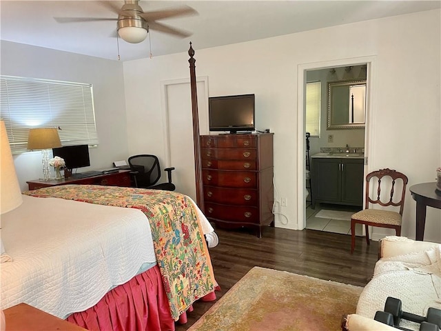 bedroom featuring sink, dark hardwood / wood-style floors, ceiling fan, and connected bathroom