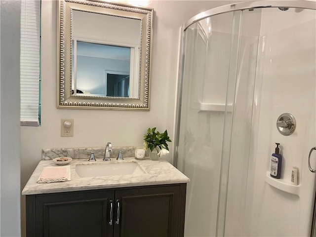 bathroom with walk in shower and vanity