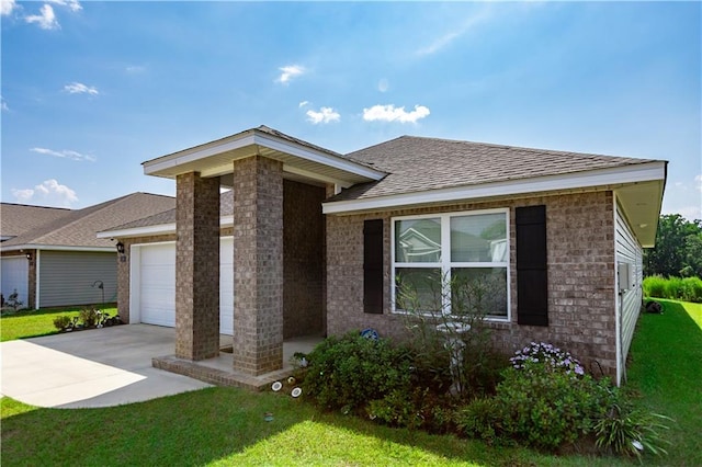 view of front of house featuring a garage and a front lawn