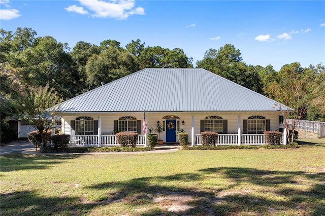 view of front of house with a garage, a front lawn, and a porch