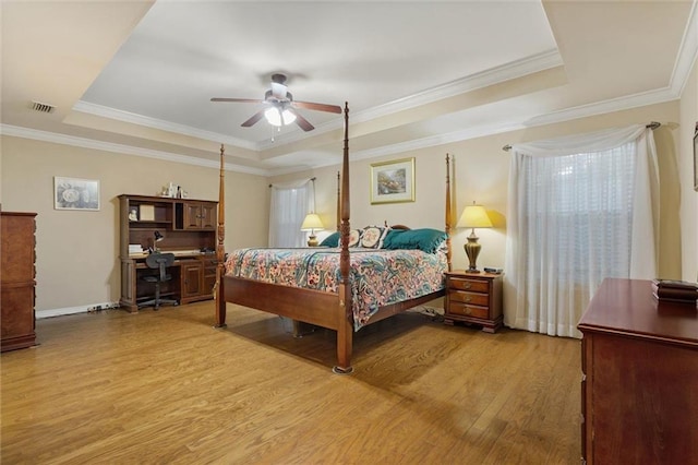 8719 Leven Ct, Mobile, AL 36695 - bedroom featuring a tray ceiling, light wood-type flooring, an office area, crown molding, and a ceiling fan