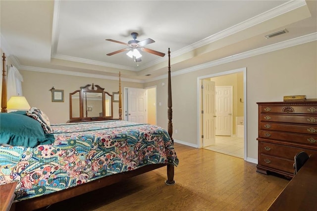 8719 Leven Ct, Mobile, AL 36695 - bedroom featuring a tray ceiling, wood finished floors, ceiling fan, crown molding, and connected bathroom