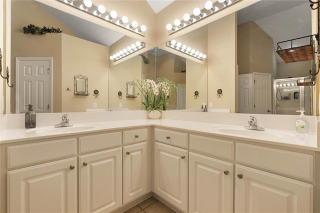 8719 Leven Ct, Mobile, AL 36695 - bathroom featuring double vanity, vaulted ceiling, and tile patterned flooring