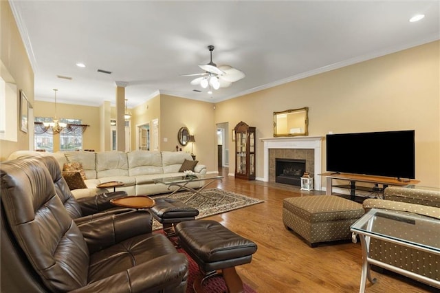 8719 Leven Ct, Mobile, AL 36695 - living room featuring a chandelier, a ceiling fan, crown molding, wood finished floors, and recessed lighting