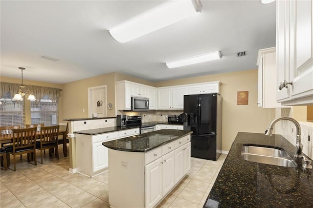 8719 Leven Ct, Mobile, AL 36695 - kitchen featuring black fridge, electric range oven, a peninsula, stainless steel microwave, and light tile patterned flooring