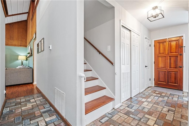 4250 Tara Dr W, Mobile, AL 36619 - entrance foyer featuring brick flooring, baseboards, and stairway