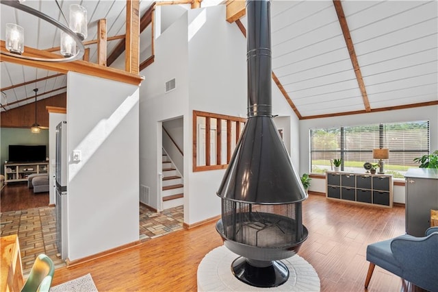 4250 Tara Dr W, Mobile, AL 36619 - living area featuring beamed ceiling, wood finished floors, stairway, high vaulted ceiling, and baseboards