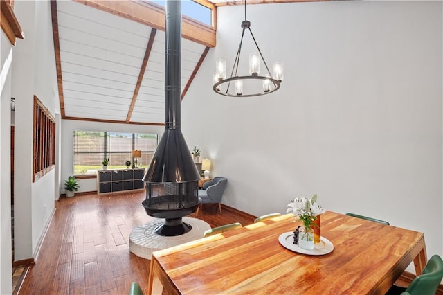 4250 Tara Dr W, Mobile, AL 36619 - dining room featuring a chandelier, wood-type flooring, baseboards, and a wood stove