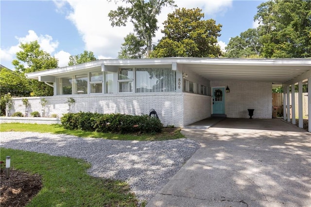 506 Barksdale Dr E, Mobile, AL 36606 - view of front of home featuring driveway, brick siding, and a carport