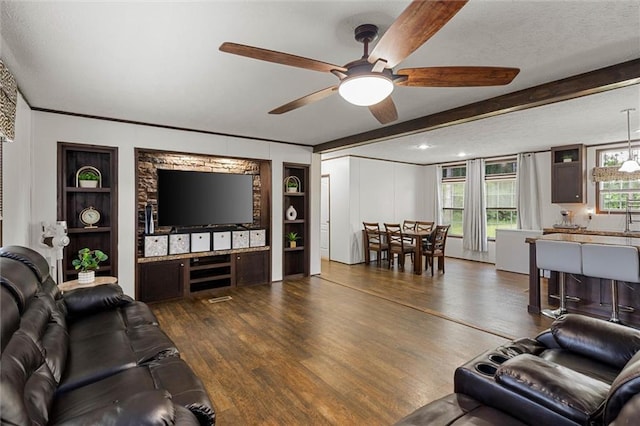 8801 Jack Williams Rd, Wilmer, AL 36587 - living area with ceiling fan, dark wood-style floors, built in shelves, ornamental molding, and a textured ceiling
