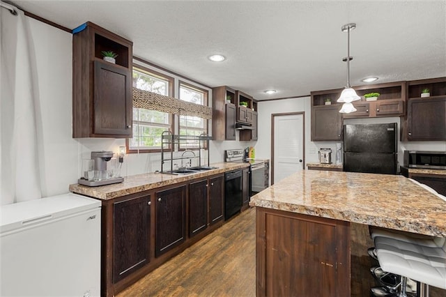 8801 Jack Williams Rd, Wilmer, AL 36587 - kitchen with black appliances, open shelves, dark brown cabinetry, dark wood finished floors, and a kitchen breakfast bar