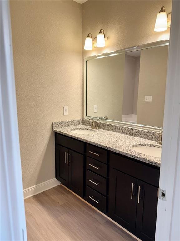 bathroom with vanity and hardwood / wood-style floors