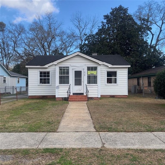 view of front of property featuring a front lawn and central air condition unit