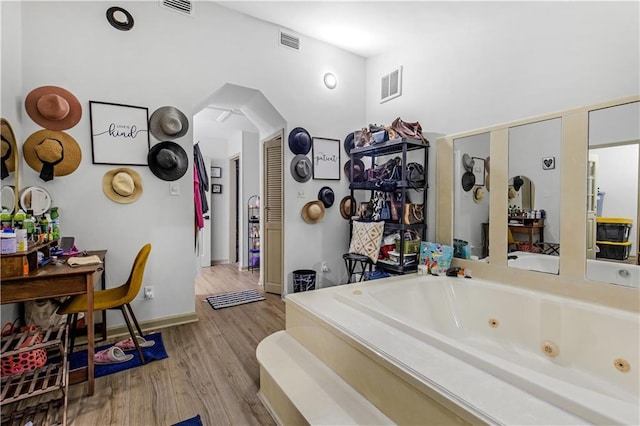 bathroom featuring hardwood / wood-style floors and a bathing tub