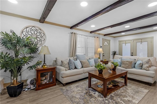 living room with light wood-type flooring, beamed ceiling, and french doors