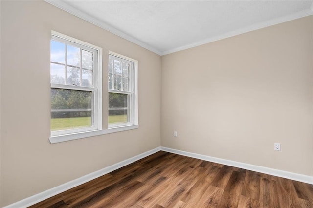 spare room with crown molding and dark hardwood / wood-style floors