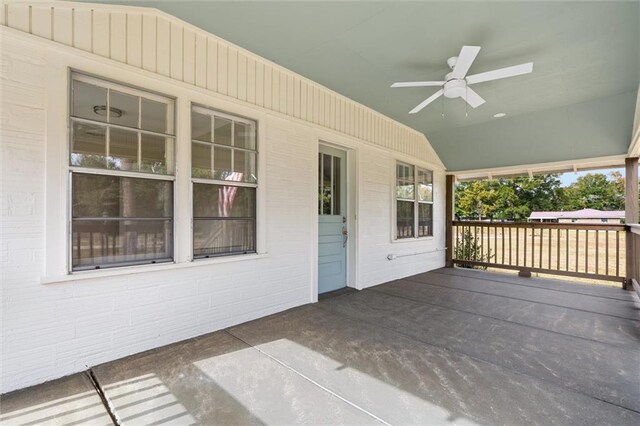 wooden terrace featuring ceiling fan and a porch