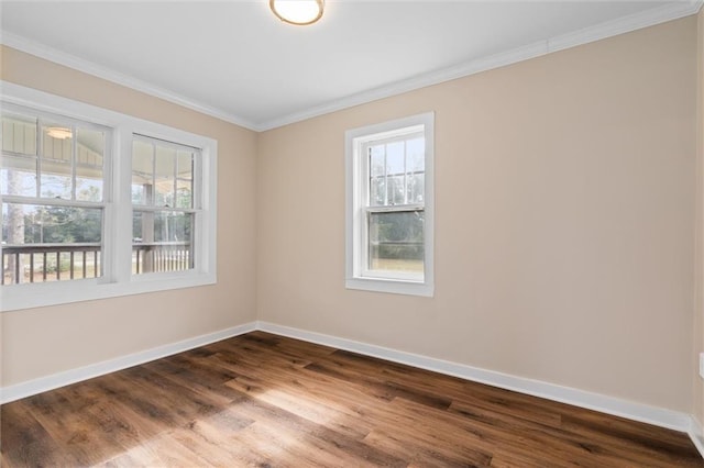 spare room with dark hardwood / wood-style flooring and ornamental molding