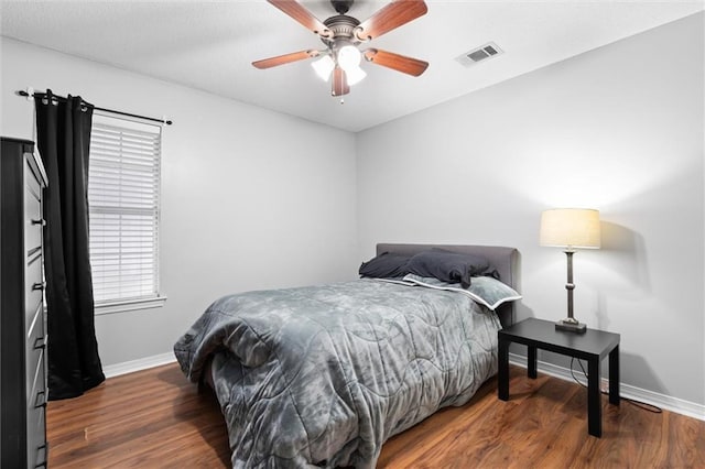 bedroom featuring ceiling fan and dark wood-type flooring