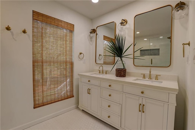 bathroom featuring a shower with door, vanity, and a healthy amount of sunlight