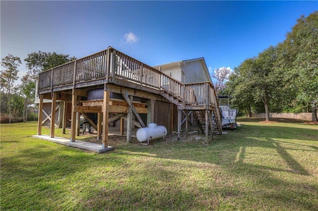 back of house featuring a wooden deck and a lawn