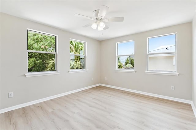 unfurnished room with light wood-type flooring, plenty of natural light, and ceiling fan