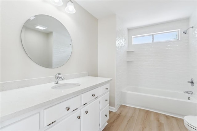 full bathroom with hardwood / wood-style floors, vanity, shower / bathtub combination, and toilet