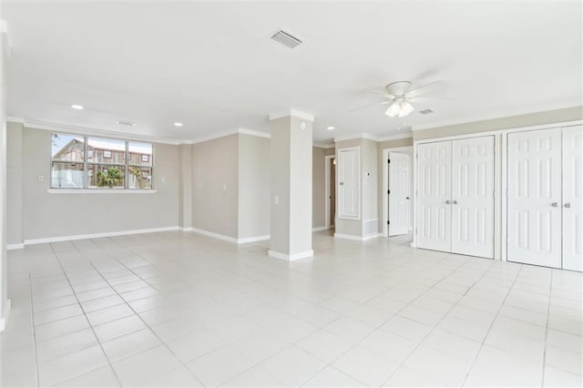 empty room with light tile patterned floors, ceiling fan, and crown molding