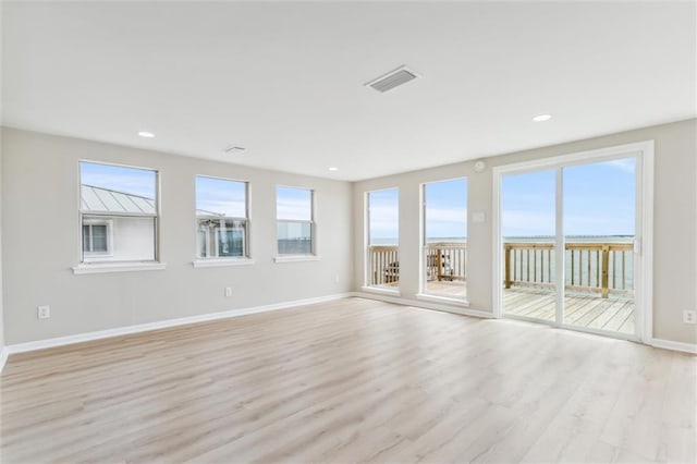 spare room featuring light hardwood / wood-style flooring