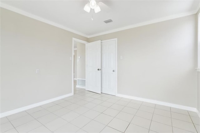 tiled spare room with ceiling fan and ornamental molding